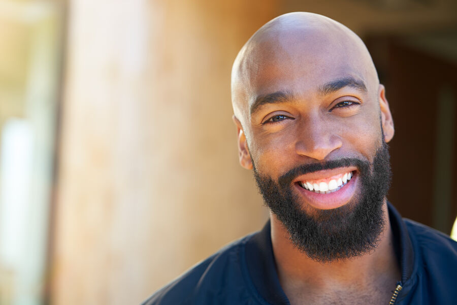 An African American man outdoors in soft late-day light