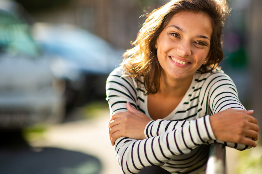 Close-up of a young mother smiling softly outside